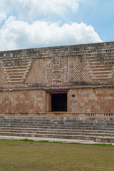 Fototapeta na wymiar Facade of a Maya building, in the archaeological area of Ek Balam, on the Yucatan peninsula