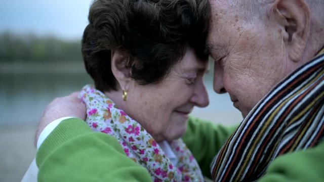 Senior couple in love standing at riverside