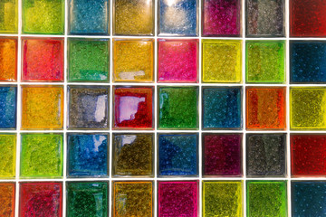 Textured surface of a bright wall of square glass blocks