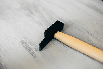 Hammer on wooden background. Closeup view of carpentry and construction tool. 