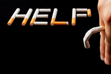bent down cigarette like impotence with word HELP on background concept of smokings dangerous