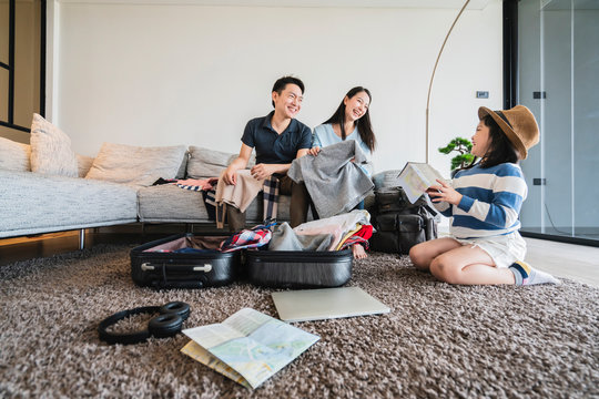 Asian Family Travel Concept Happiness Dad Mom Daughter Packing Stuff  Cloths And Planing For Vacation Road Trip With Exited And Joyful