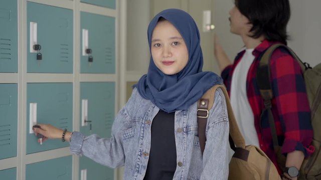 muslim asian student friend in locker room of school