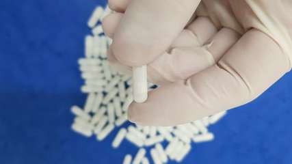 White capsules on blue background