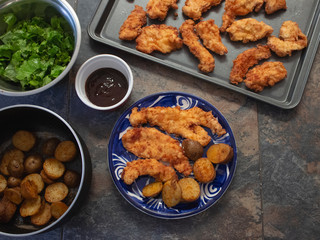 Traditional Fried Chicken Strips Plate with Potatoes and fresh Green Salad 