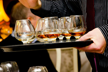 Cognac glasses on a waiters tray