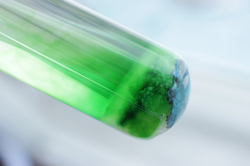 Green sediment in the tube, at the bottom of the tube is a blue precipitate of copper silicate.