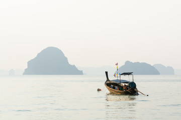 Obraz premium Long tail wooden boats moored at Klong Muang beach at sunset in Krabi province, Thailand