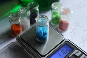 Weighing on electronic scales of copper sulfate which is an antibacterial and fungicidal substance.