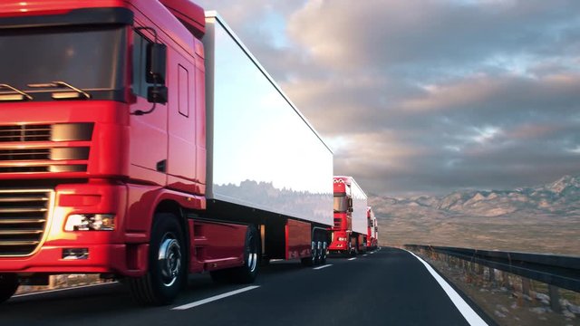 A convoy of semi trucks drives passed the camera on a highway into the sunset. Realistic high quality 3d animation.