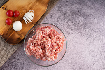 Fresh, minced meat in a plate on the table in the kitchen. Cooking minced meat for meatballs.
