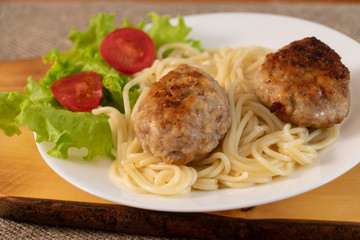 Ready meat patties with salad in a plate on the table. Dish homemade.