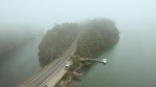 Aerial Super Dolly Fly Over Drone Footage over highway connecting into Orr's Island in Harpswell, Maine, USA.