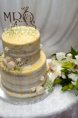 White wedding cake with flowers and macaroons