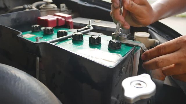 Hand close up of a msn to check and replace car battery
