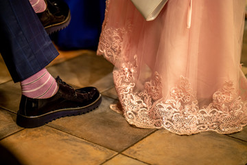 Bride and groom legs on floor