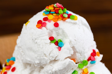 vanilla ice cream scoop swith sprinkles, close up