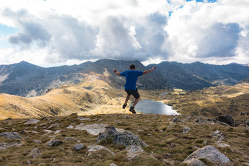 Trail runner jumping in scenic background