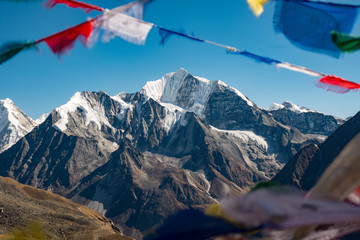 Himalayas peak of Langtang with prayer flags in foreground © Lluis Ballbe