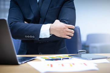 Businessman sitting with a laptop in his office