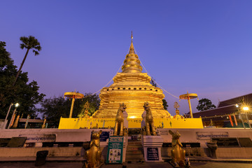 Chiang Mai, Thailand - December 27, 2018: Golden buddha relic pagoda at Wat Phra That Si Chom Thong Worawihan at twilight