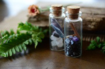 Curiosity Cabinet, whimsical woodland crystal bottles. Snowflake Obsidian, Clear Quartz, Fluorite, Blue Kyanite, and Amethyst in glass bottles. Little glass vials, fairy garden natural curiosity. 
