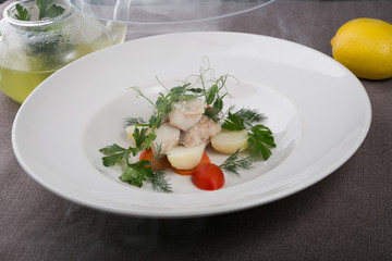 Seafood soup served with white fish fillet