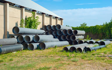 Fiberglass pipes bound with yellow rope at construction site. Also known as fiberglass conduit for electrical, industrial, and mechanical use.