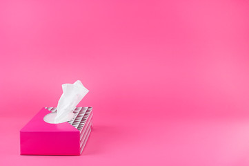 paper napkins in a pink box on a plain background. Free space for text. Copy space.