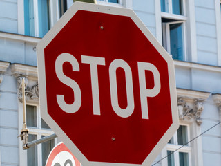 Stop sign with a building on background