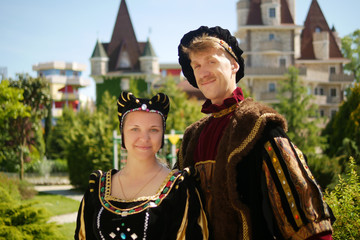 couple, duke and duchess against the backdrop of the castle in a beautiful park