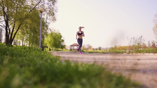 Girl doing morning run in the park early in the morning