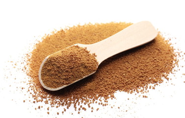 Coconut palm sugar with wooden spoon isolated on white 