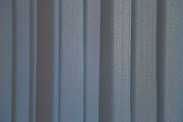 Textured surface of colored vertical textile blinds