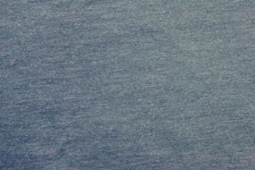 Pale faded bluish cloth fragment texture of colorless worn out sweater background 