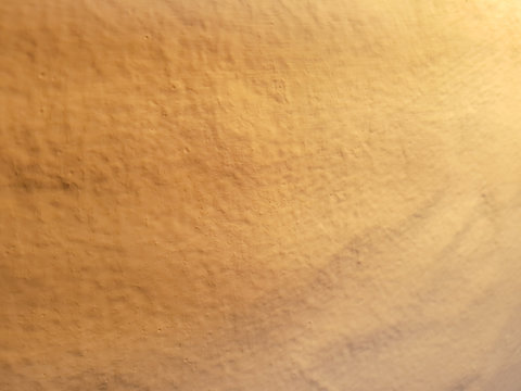 Brown clay wall backdrop with side lighting