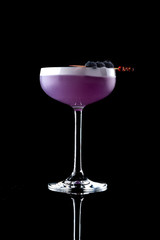 cocktail purple color in a chalet on a black background