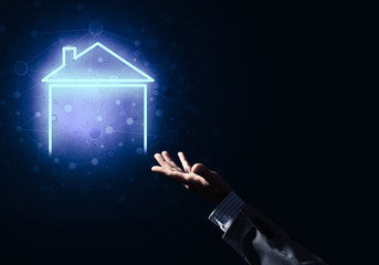 Conceptual image with hand pointing at house or main page icon on dark background