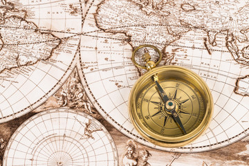 Fototapeta na wymiar Compass on vintage ancient map, concept for direction transportation and travel