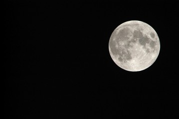 View, of a phase, of the lunar eclipse through a telephoto lens in Turin, Italy