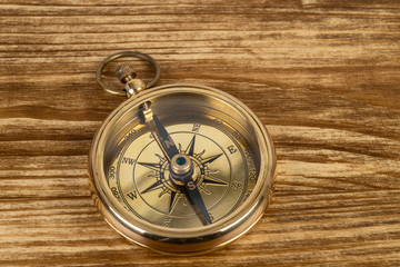 Compass on wooden background, concept for direction transportation and travel