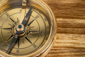 Compass on wooden background, concept for direction transportation and travel