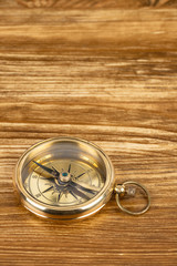 Fototapeta na wymiar Compass on wooden background, concept for direction transportation and travel, with copy space