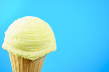 Ice-cream scoop in waffle ice cream cone with copy space. Summer background, vacation, refreshment, traditional seasonal cold sweets