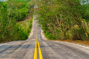 Country road in the forest , Highway road in Thailand between the hills.