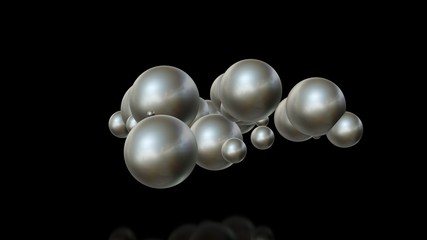 3D illustration of metal balls of different sizes randomly arranged in space and penetrating into each other. A futuristic image, an abstraction. 3D rendering isolated on black background.