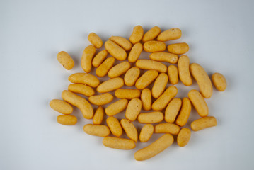 snack crisps chip yellow from fish flavored in capsule shape ellipse on plain isolated white background
