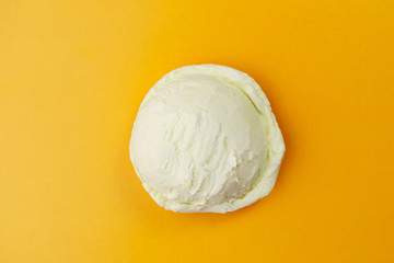 Ice-cream scoop on bright sunny background, copy space. Summer vacation, refreshment, traditional seasonal cold sweets