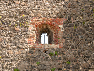 Section of wall with barred window at Carrickfergus Castle, Northern Ireland