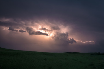 Lightning flashes from cloud to cloud in a supercell thunderstorm over the plains of North Dakota